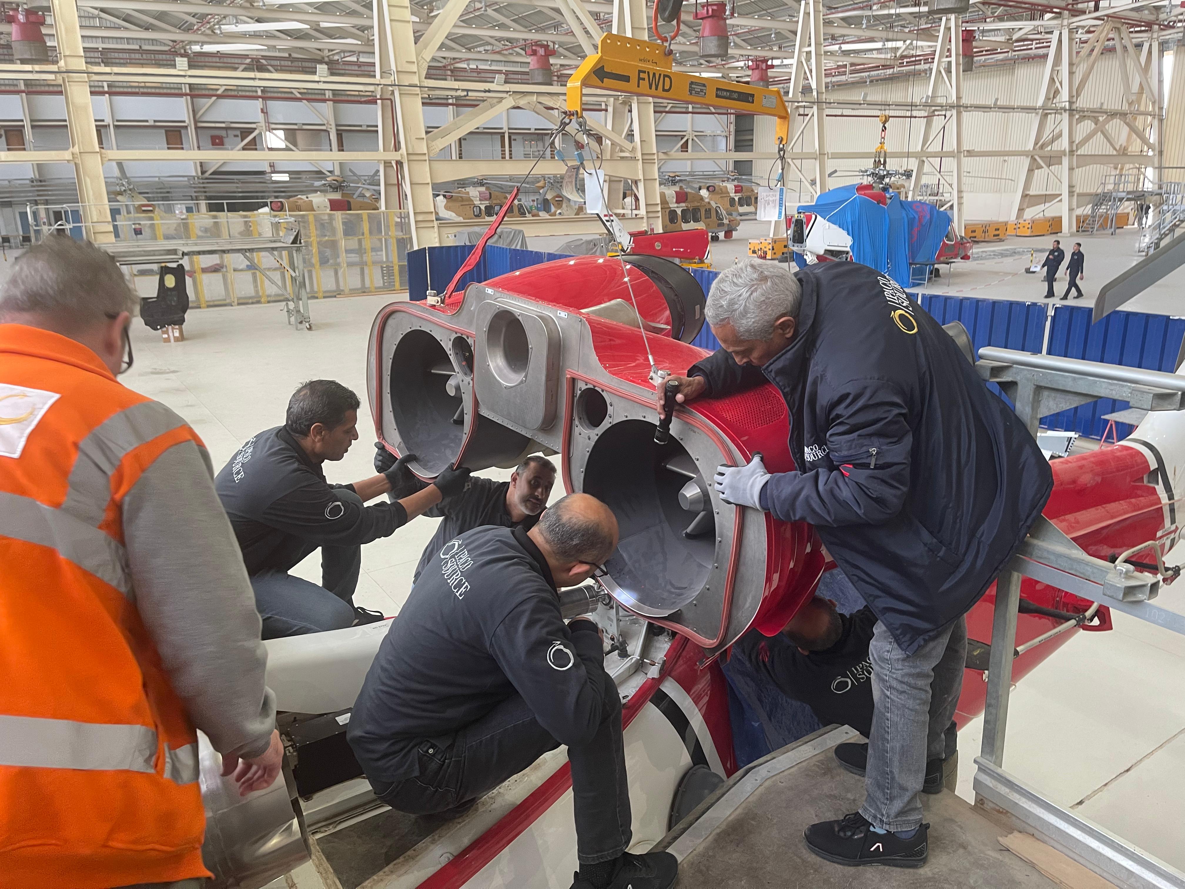 Crew working on helicopter upper structure