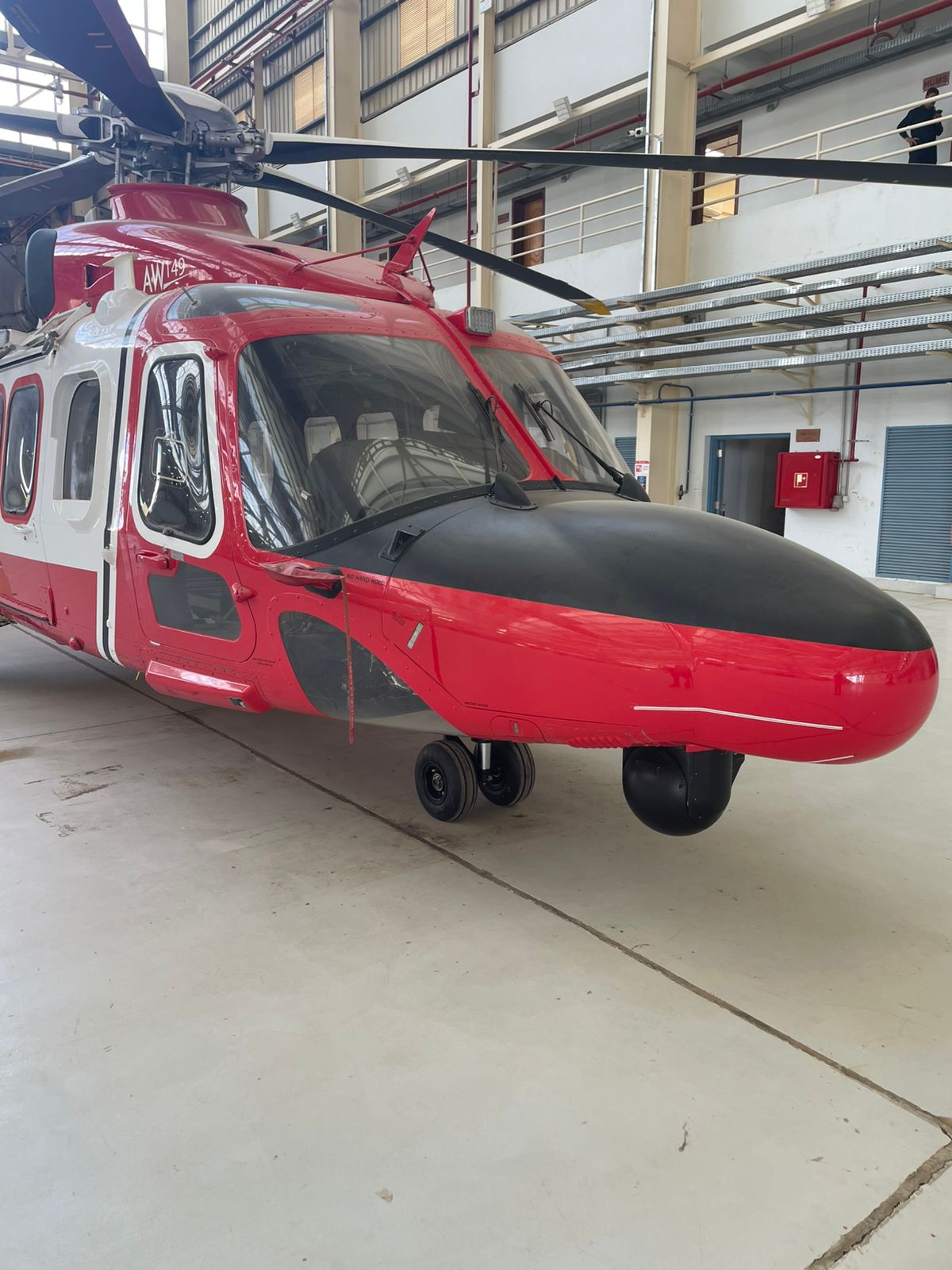 AW-family helicopter in hangar